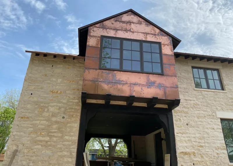 Copper metal panel facade on a stone building for Skylight Installation in Northglenn