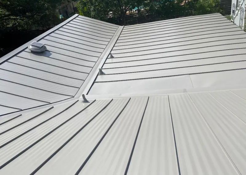 Solar attic fan installed on a metal roof for Roof Ventilation in Northglenn